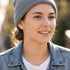 Woman wearing peace symbol stainless steel stud earrings.