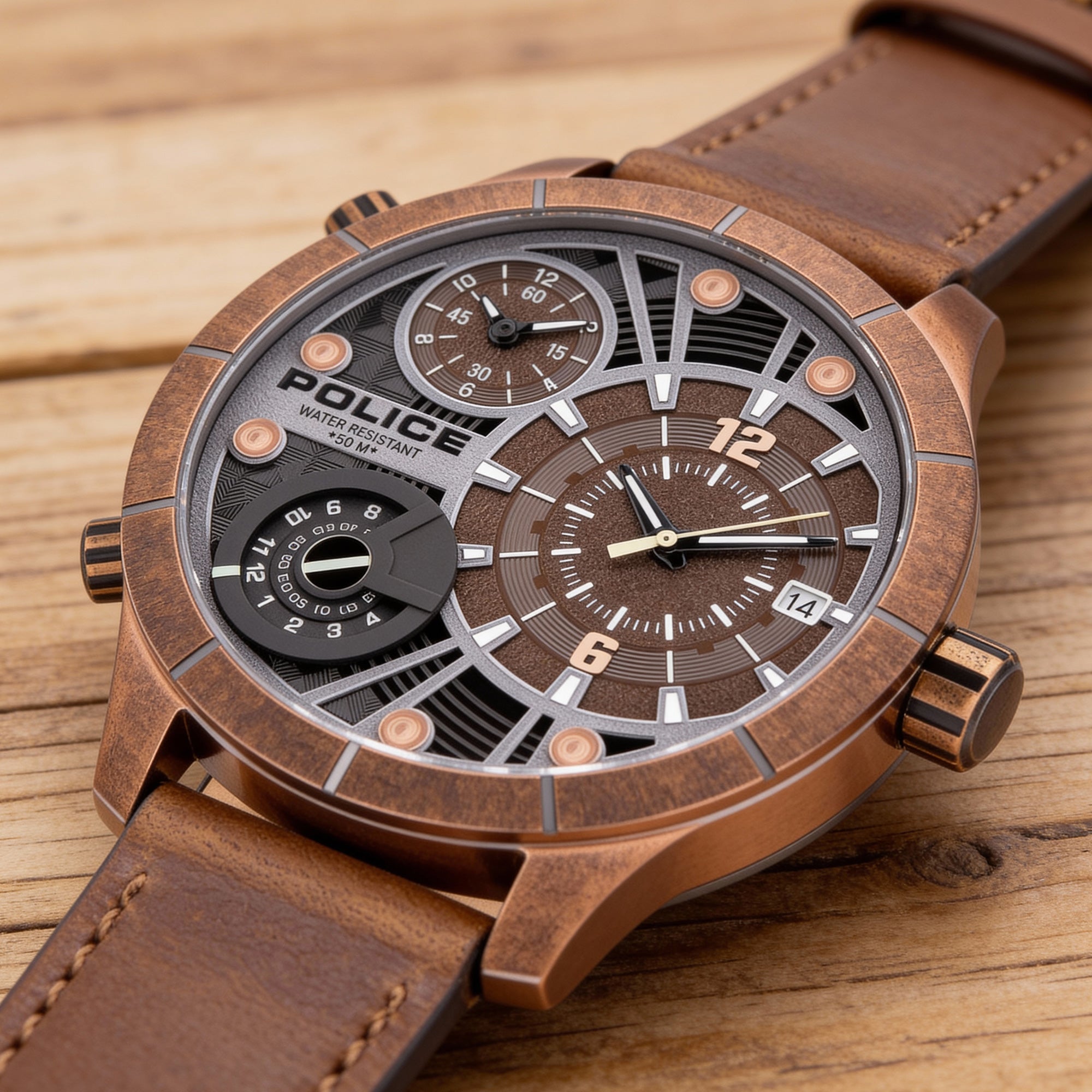 Police Bushmaster brown leather men's watch on a wooden surface.
