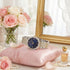 Police ladies Dazzle royal blue dial two tone watch on a pink pillow, surrounded by flowers and a mirror.