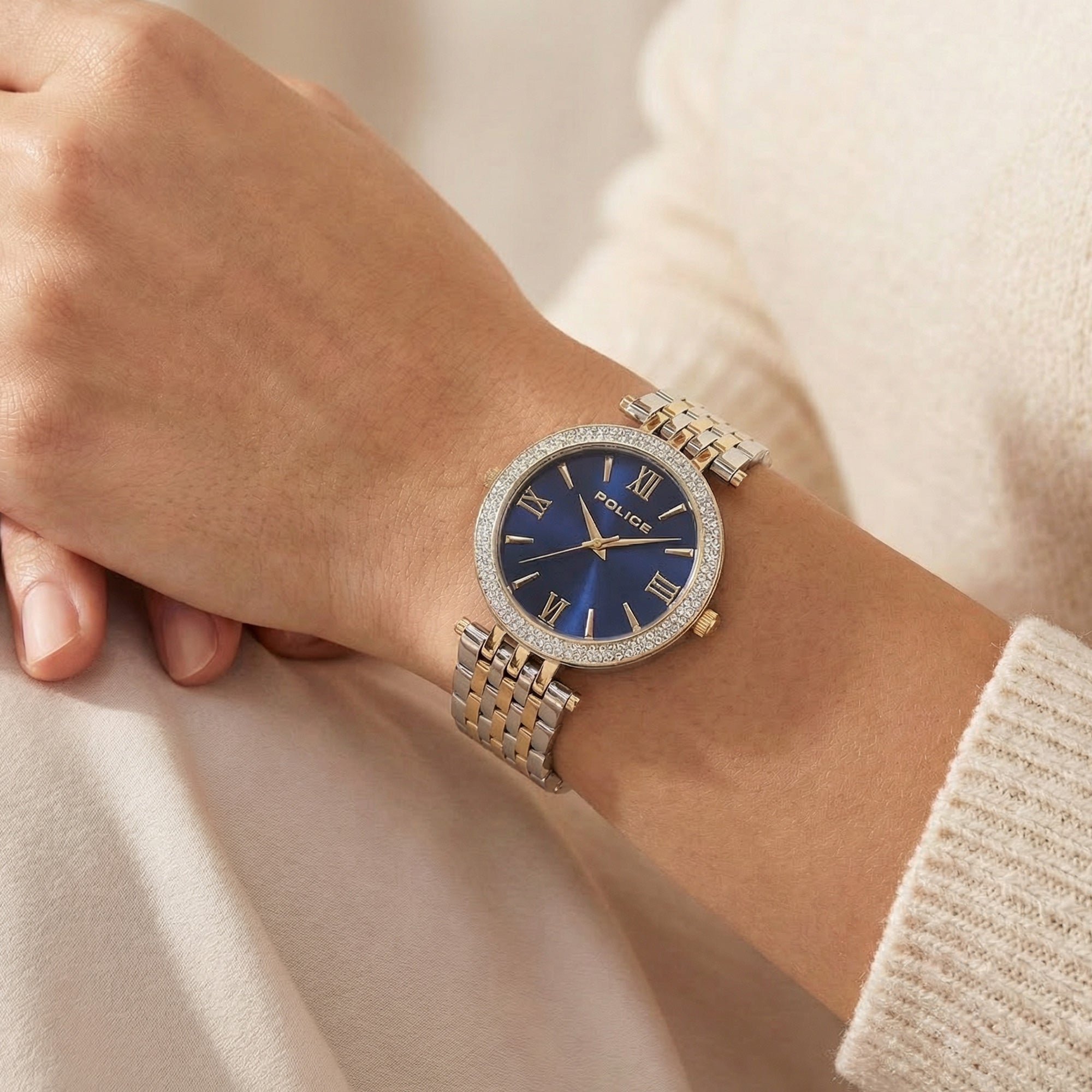 Woman wearing Police ladies Dazzle royal blue dial two tone watch.