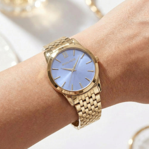 Woman wearing Police ladies Celebration powder blue dial gold watch.