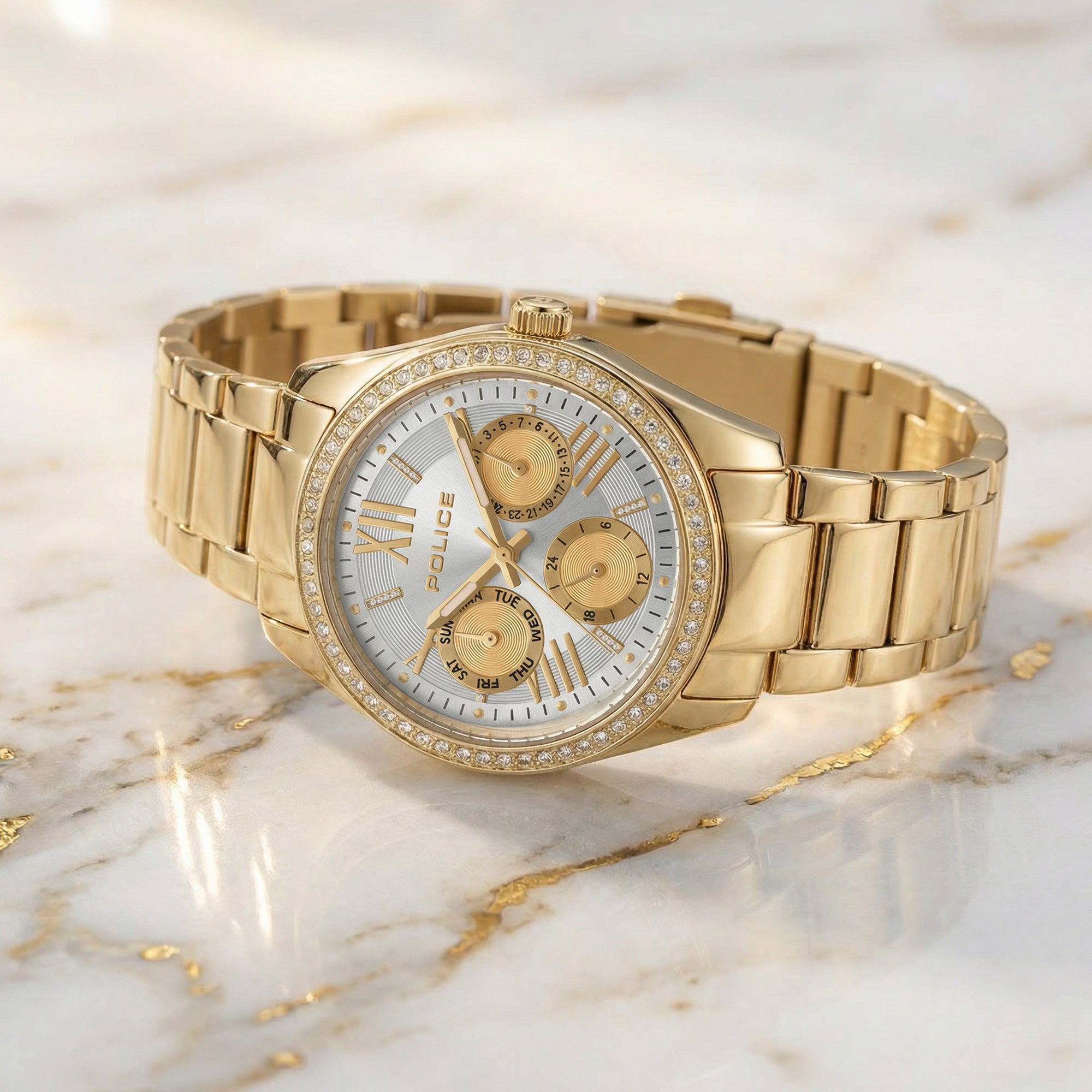 Police ladies Concerto Gold Watch laying on white marble with gold seam.