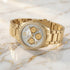 Police ladies Concerto Gold Watch laying on white marble with gold seam.
