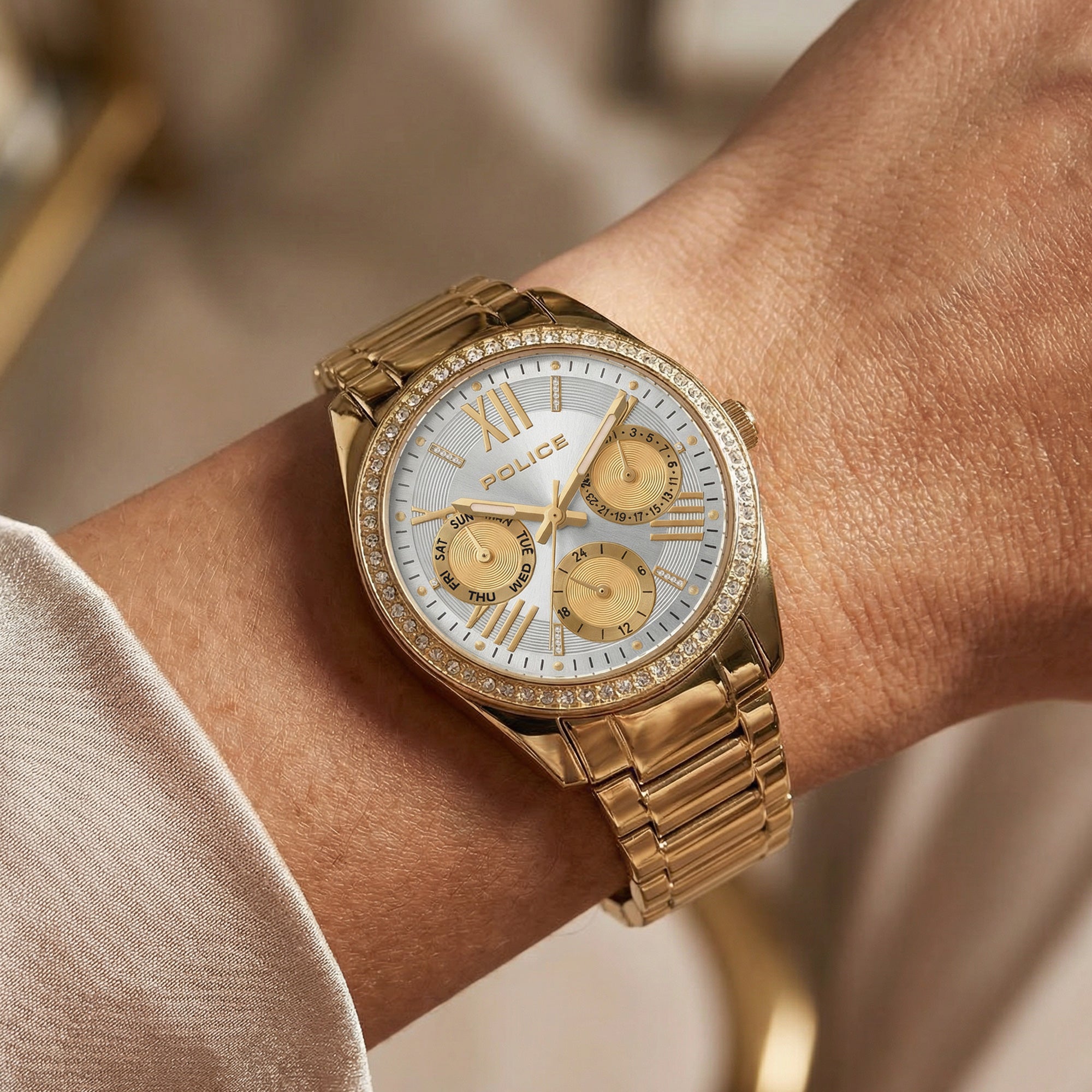 Woman wearing a Police ladies Concerto gold watch.