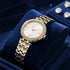 Police ladies Magnificence gold two-tone watch displayed on blue velvet cushion.