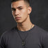 Young man wearing Police Men In Black stainless steel dog tag limited edition necklace.