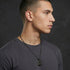 Young man facing right wearing Police Men In Black stainless steel dog tag limited edition necklace.