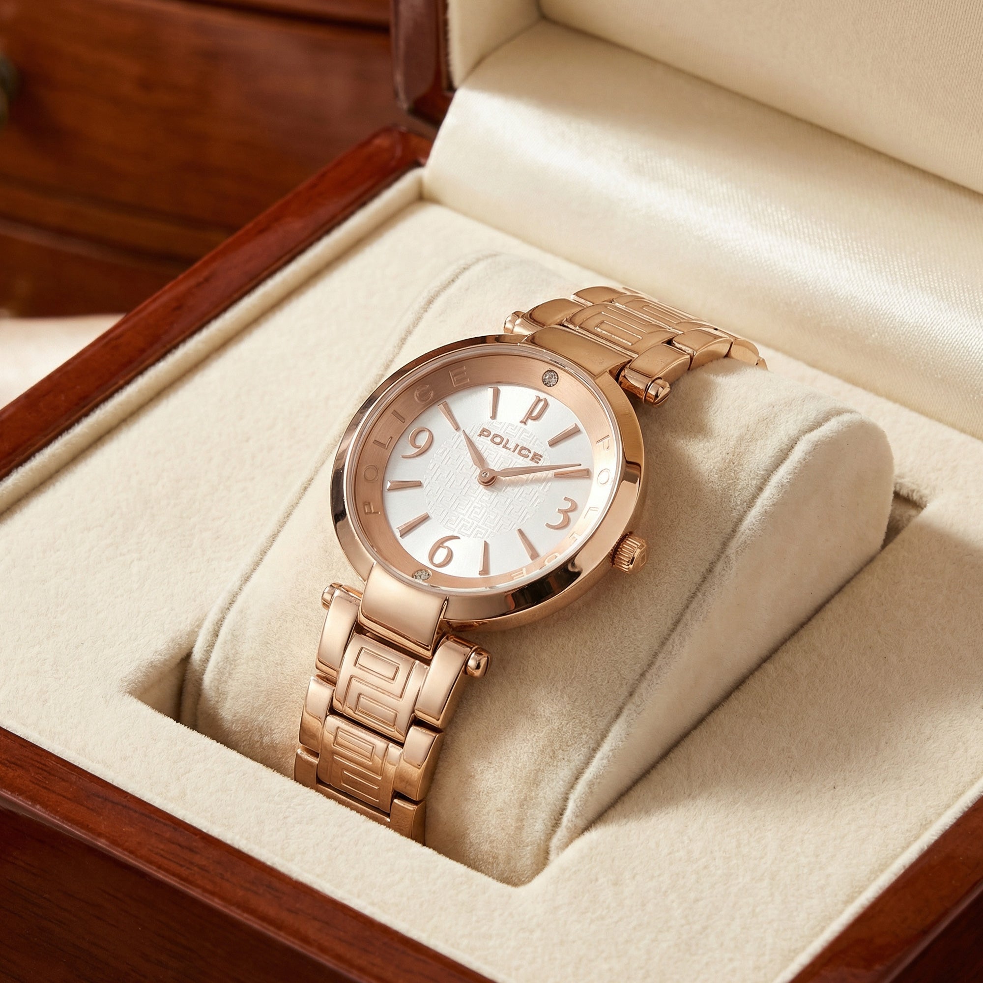 Police ladies Attraction pearl dial rose gold watch in a velvet and wood watch box.