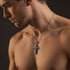 Video of a shirtless man wearing a sterling silver lashed wood cross necklace.