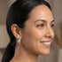 Side view of woman looking to the right wearing Ellani rainbow silver channel set hoop earrings.