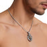 Close-up of man wearing stainless steel roaring lion head king crown necklace.