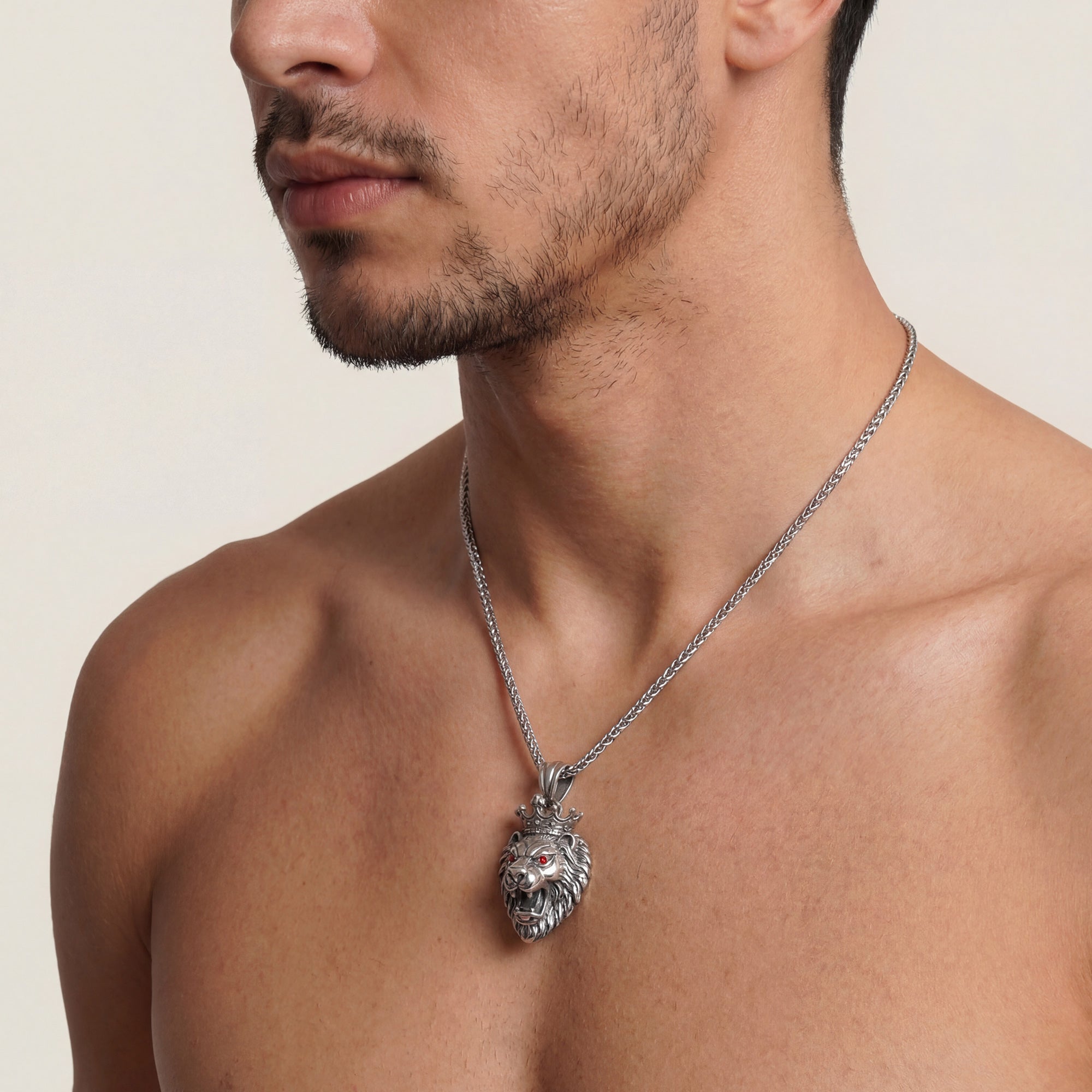 Man wearing stainless steel roaring lion head king crown necklace.