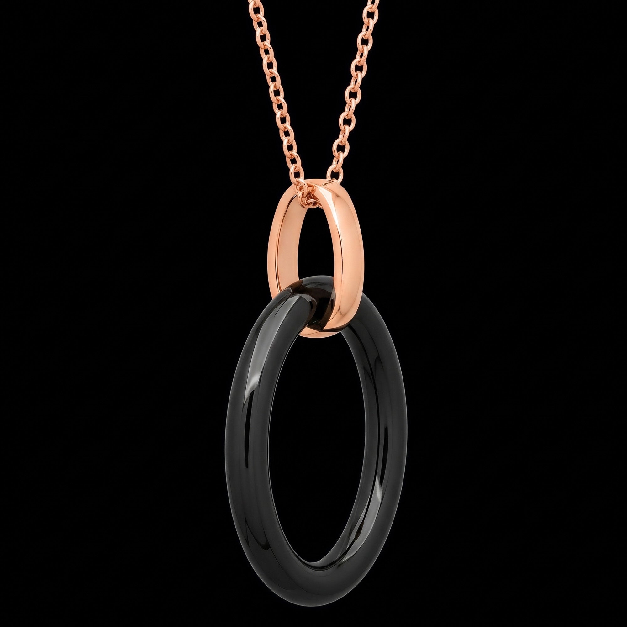 Side angle view of a sterling silver rose gold black ceramic oval necklace.