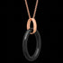 Side angle view of a sterling silver rose gold black ceramic oval necklace.
