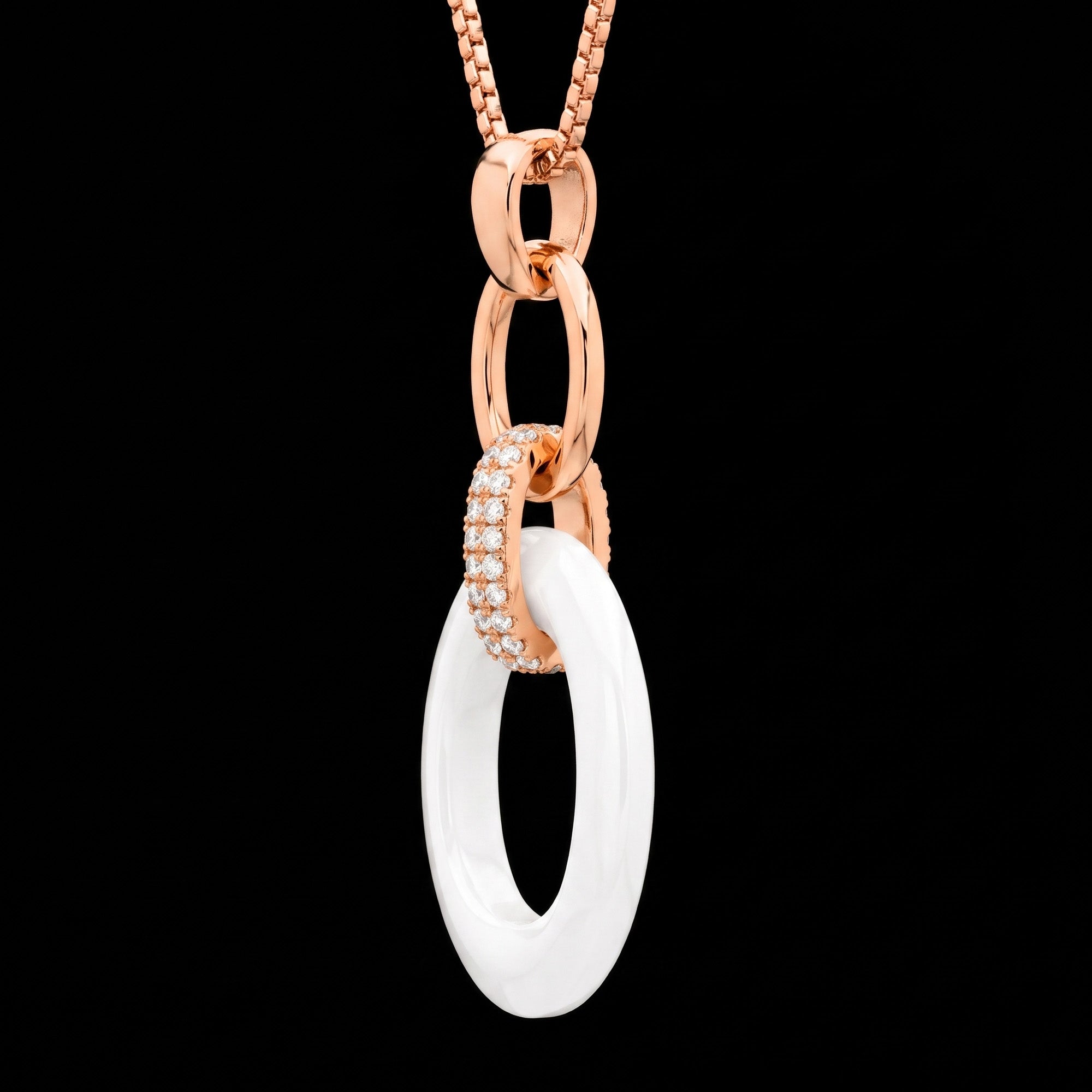 Tilt side view of a sterling silver rose gold white ceramic oval link CZ necklace.