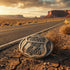 A route 66 belt buckle laying on the side of a dessert highway.