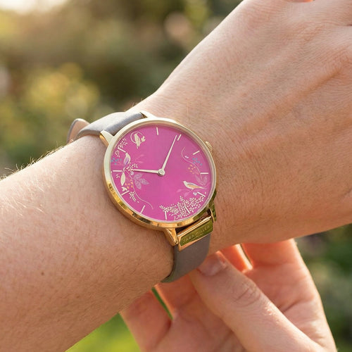 Woman wearing Sara Miller Chelsea Birds 34mm pink dial gold watch.