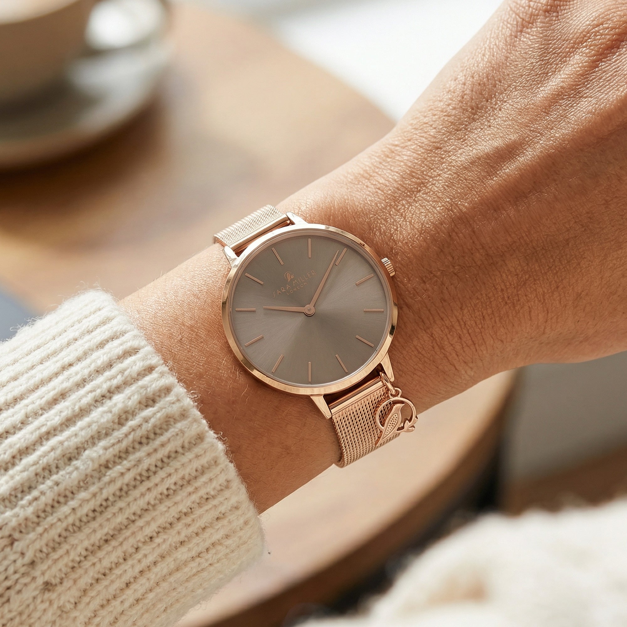 Woman wearing Sara Miller Chelsea Charm 34mm mocha rose gold mesh watch.