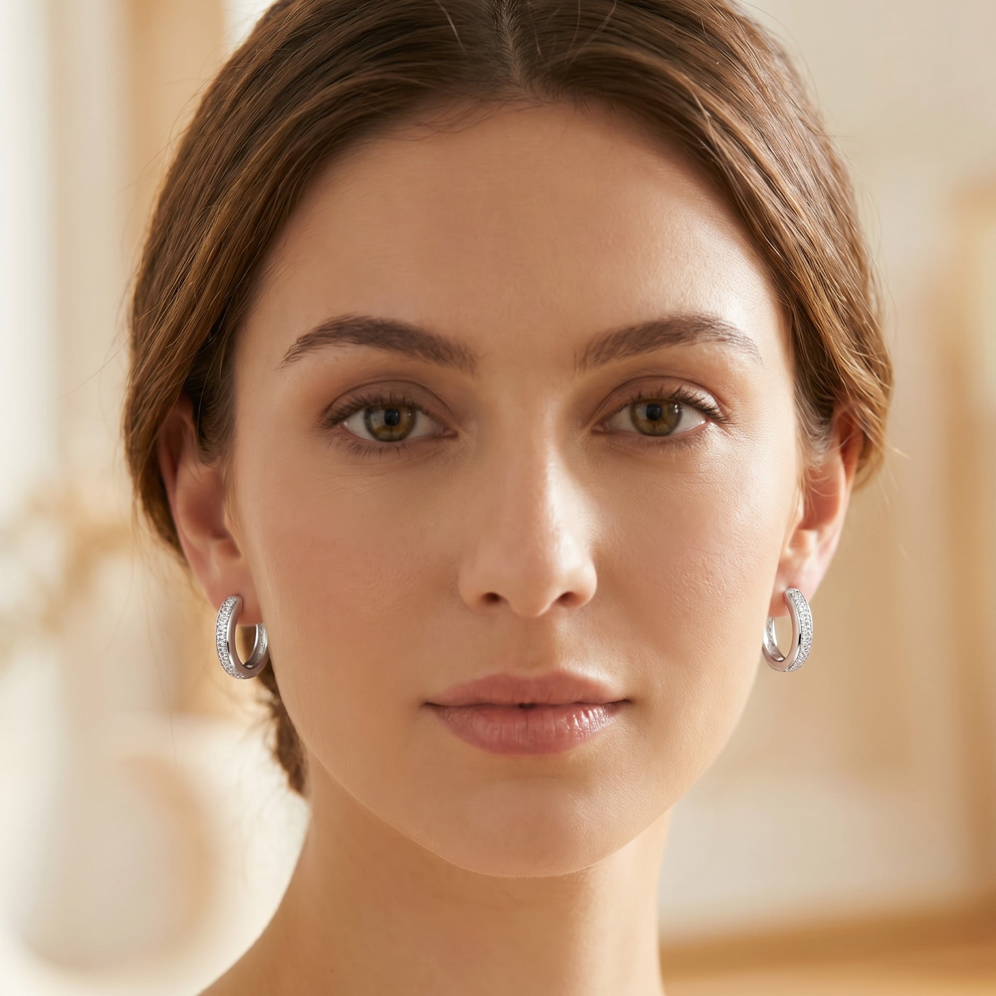 Woman wearing a pair of Engelsrufer sterling silver 20mm CZ hoop earrings.