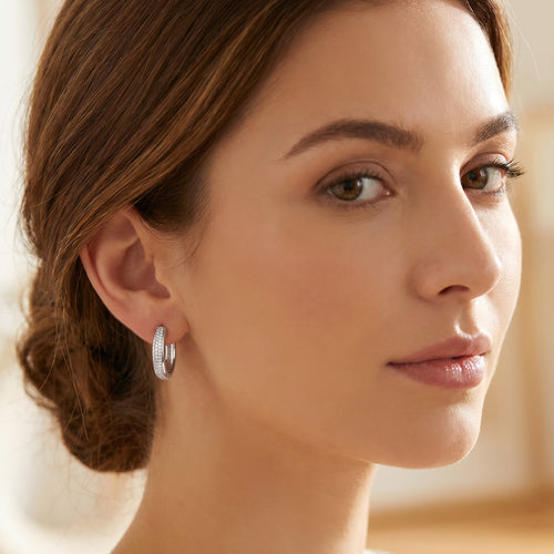 Woman wearing Engelsrufer sterling silver 20mm CZ hoop earrings.