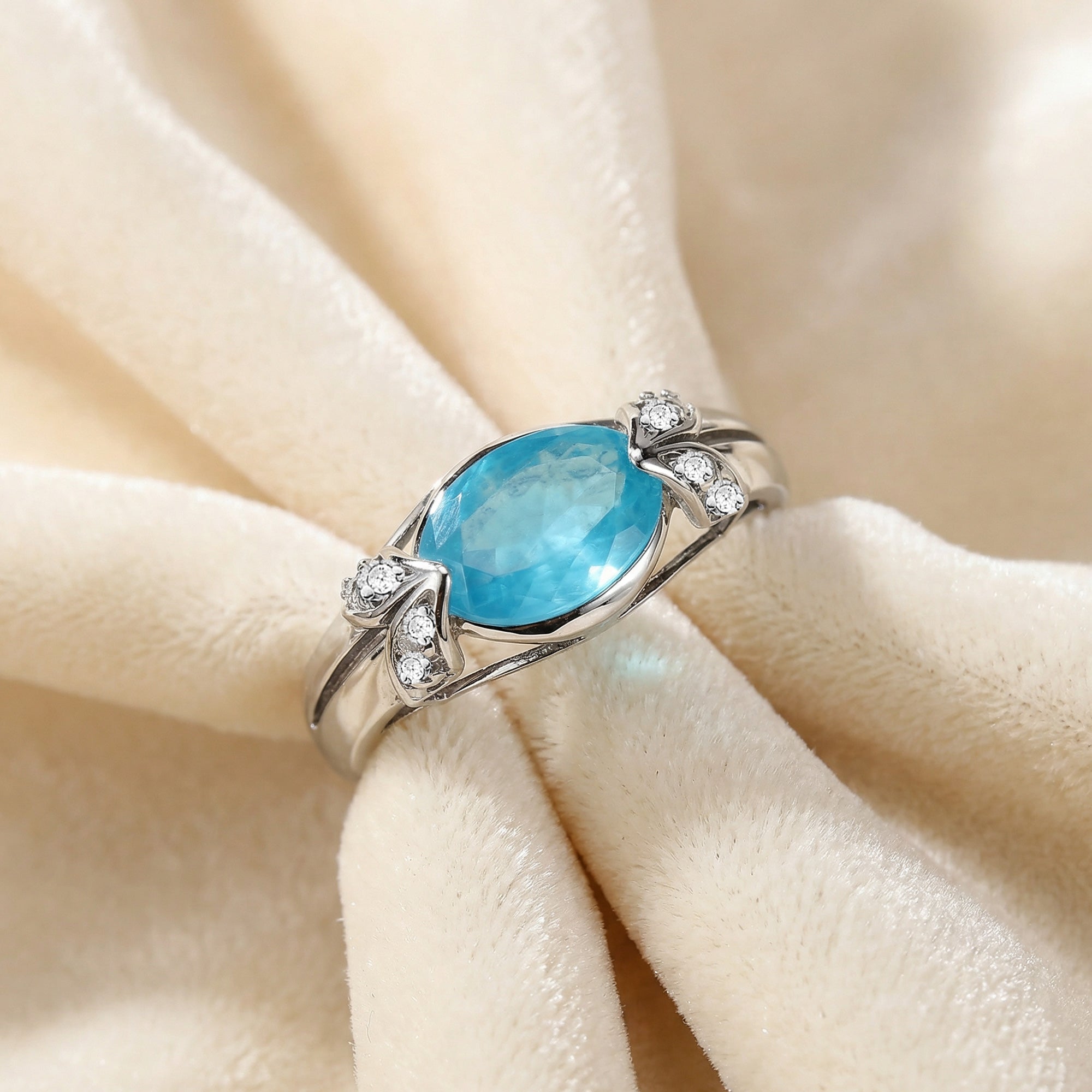 Sterling silver oval cut aquamarine ladies ring on soft fabric.