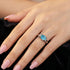 Woman wearing sterling silver oval cut aquamarine ladies ring on her hand.