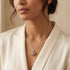 Woman wearing an Engelsrufer sterling silver red heart soundball necklace.