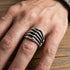 Close-up of man's hand wearing stainless steel men's skeleton hand ring.