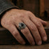 Man wearing memento mori skull cluster stainless steel men's ring.