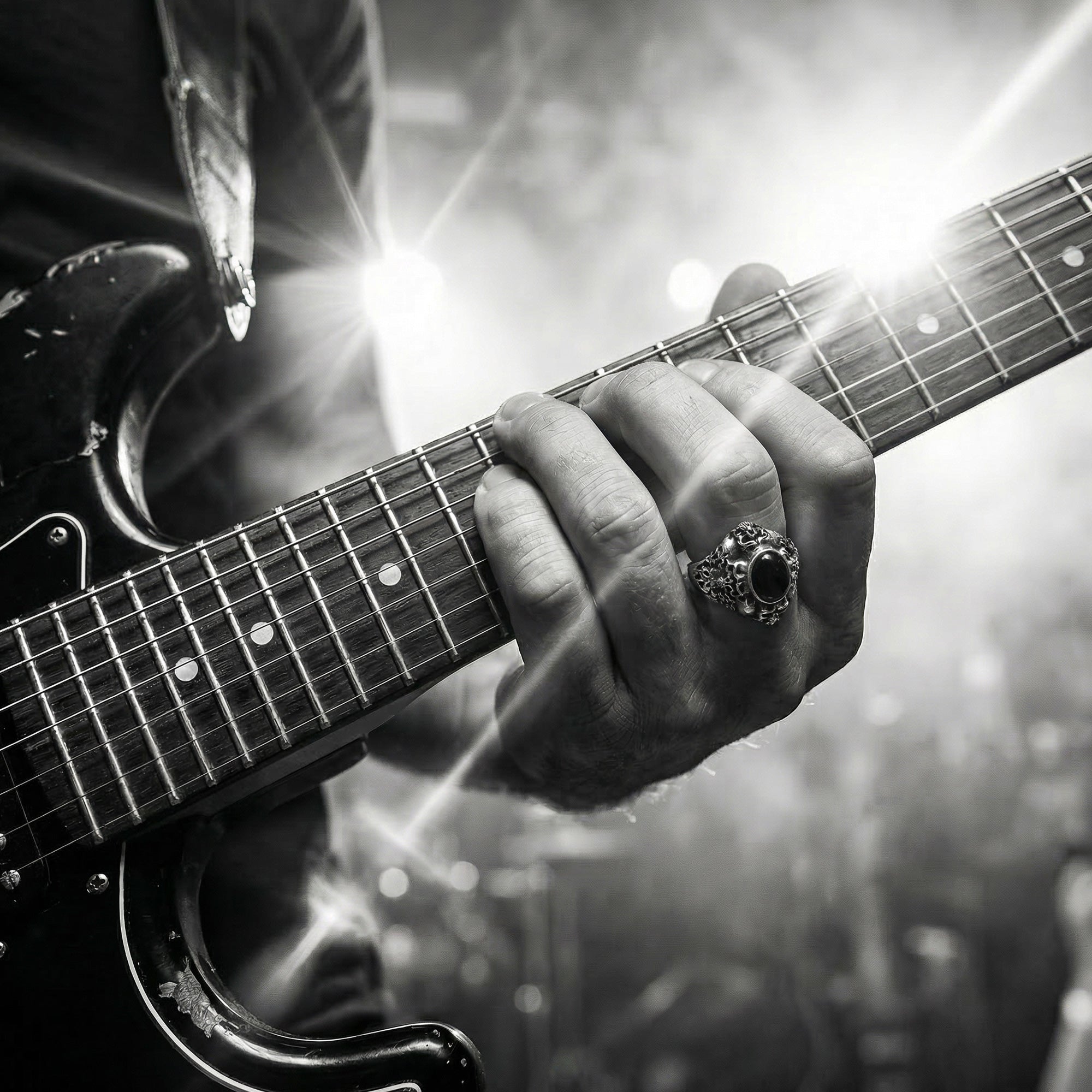 Man playing an electric guitar while wearing memento mori skull cluster stainless steel ring.