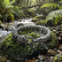 Stainless steel snake uroboros men's bracelet in bush creek setting.