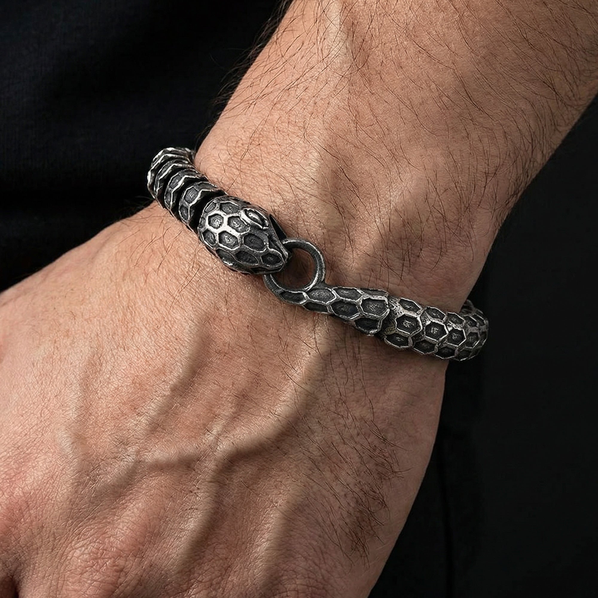 Man wearing stainless steel snake uroboros men's bracelet.