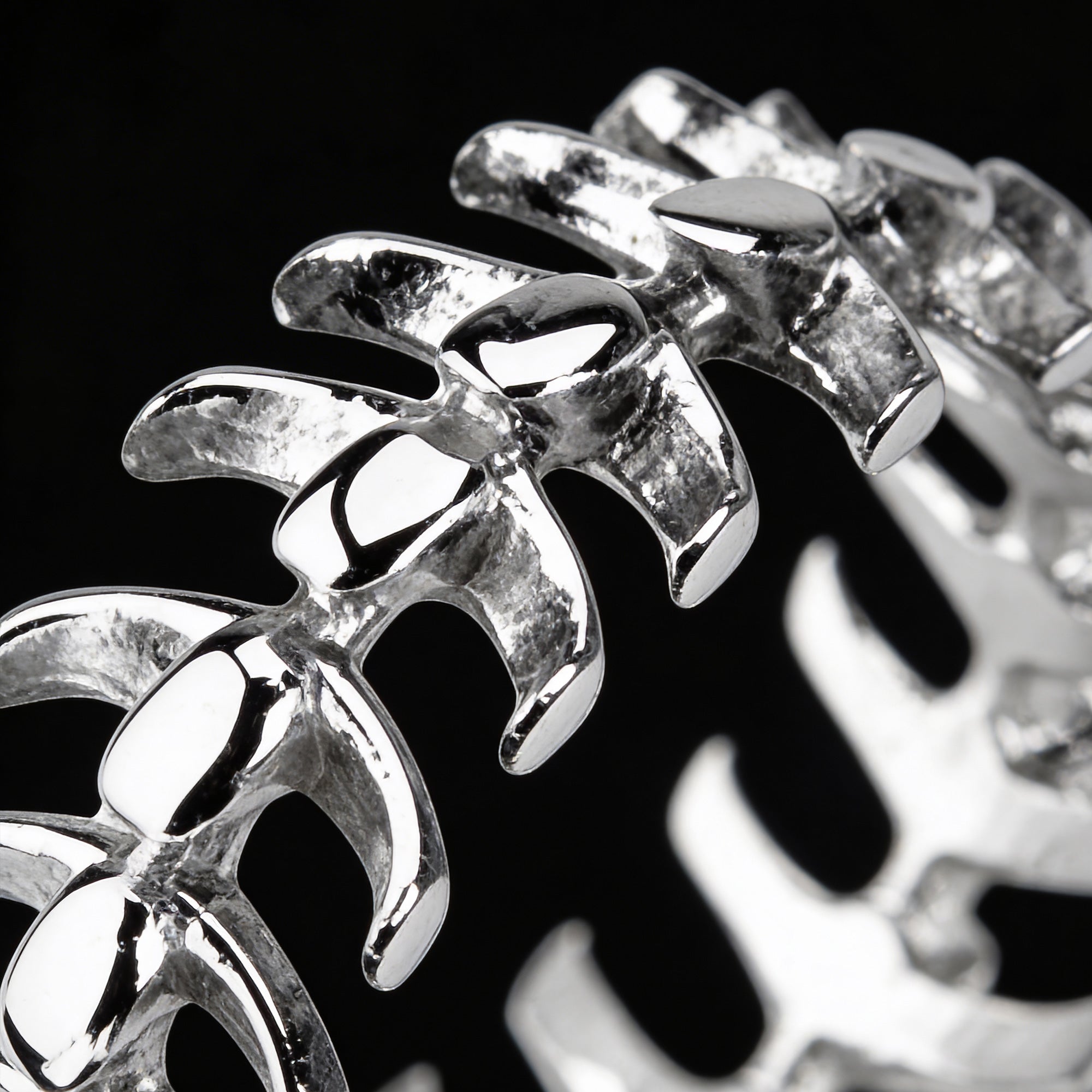 Close-up of a men's stainless steel spine vertebrae ring.