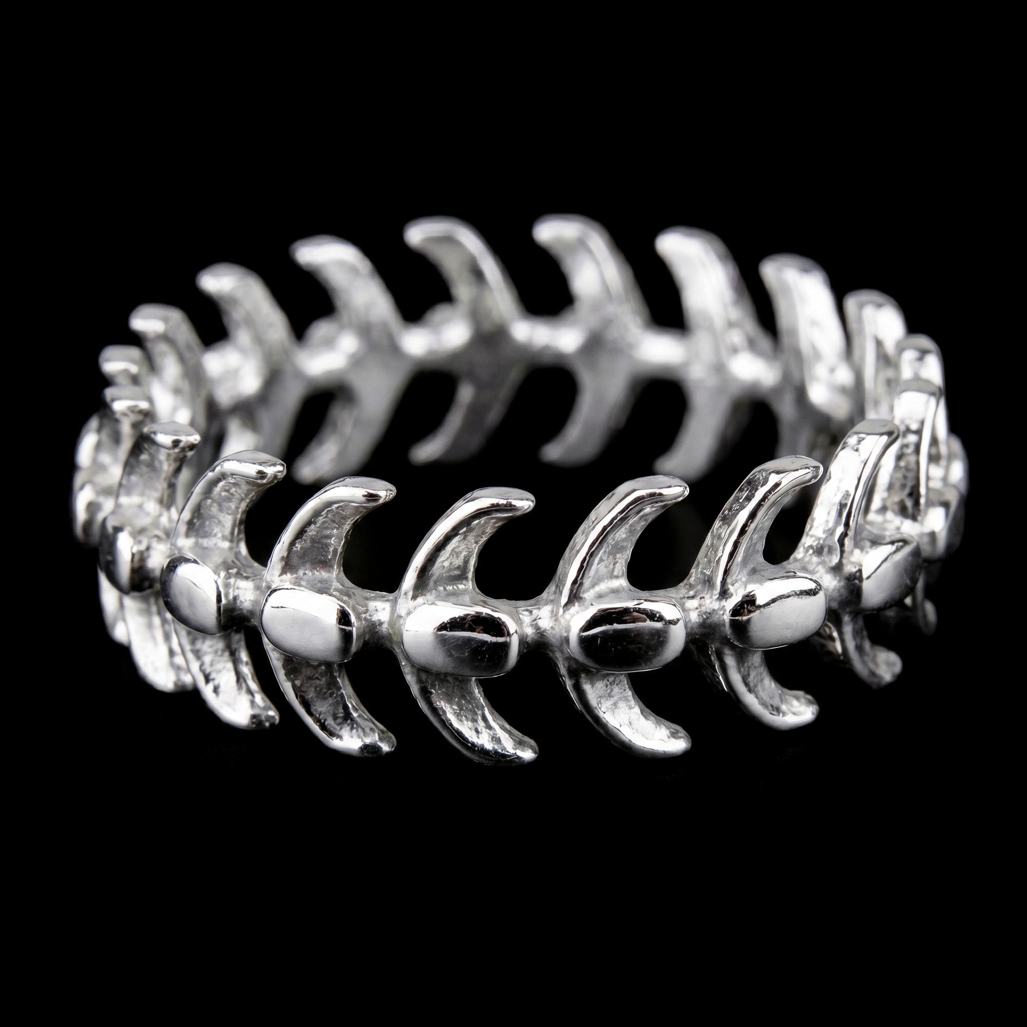 Side view of a stainless steel men's spine vertebrae ring.
