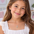 Young girl wearing Herzengel shining star heart wing silver children's necklace.