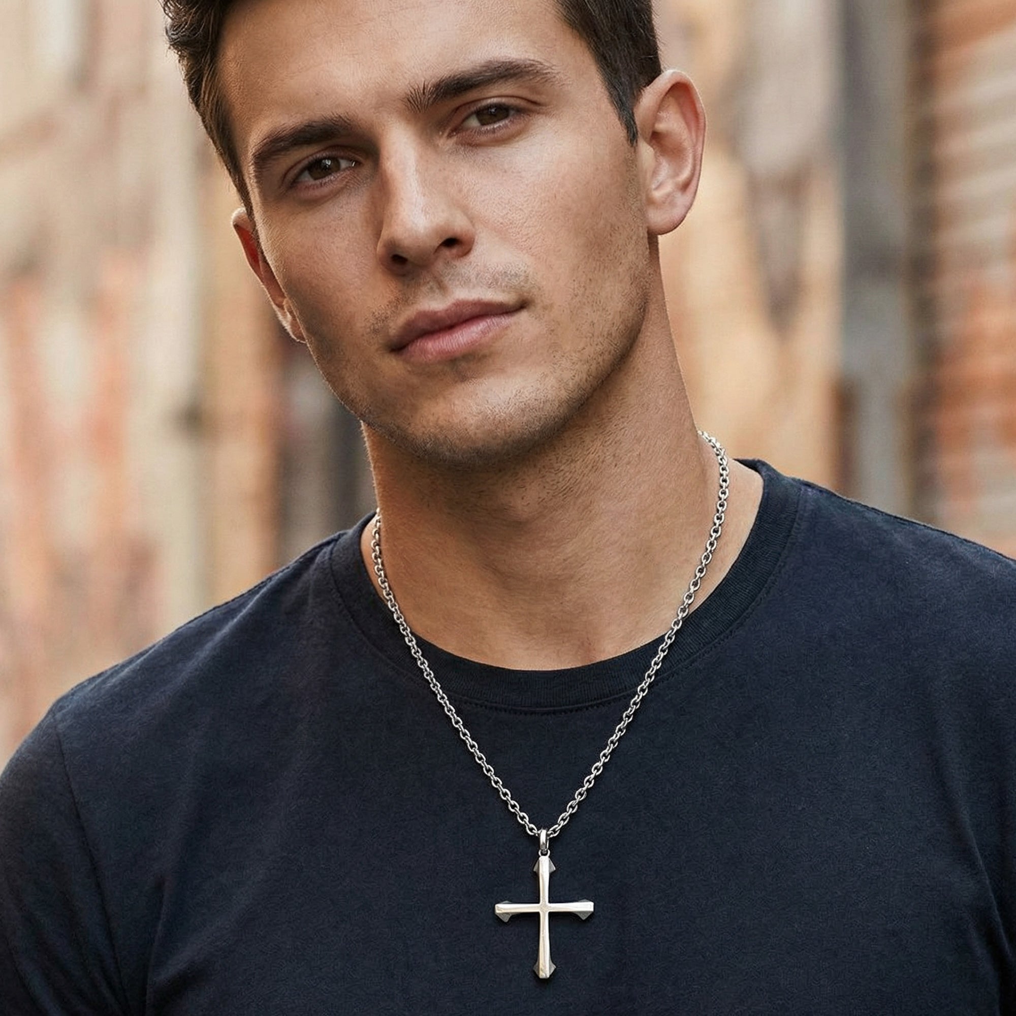 Young man wearing barbed cross stainless steel necklace.