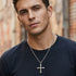 Young man wearing barbed cross stainless steel necklace.