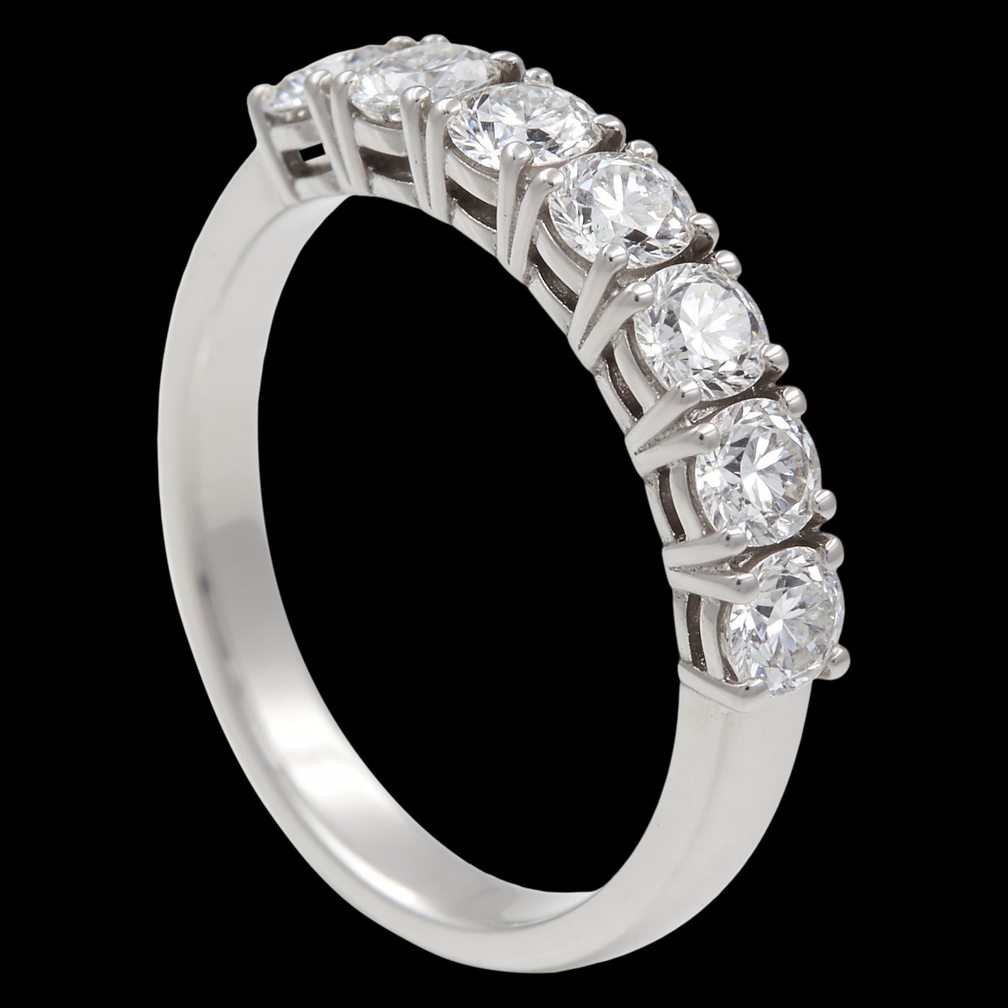 Stainless steel seven stone CZ shared prong ring sitting upright and tilted to the right.