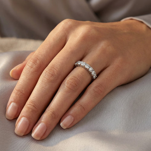 Woman wearing stainless steel seven stone CZ shared prong ring on her hand.