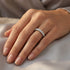 Woman wearing stainless steel seven stone CZ shared prong ring on her hand.