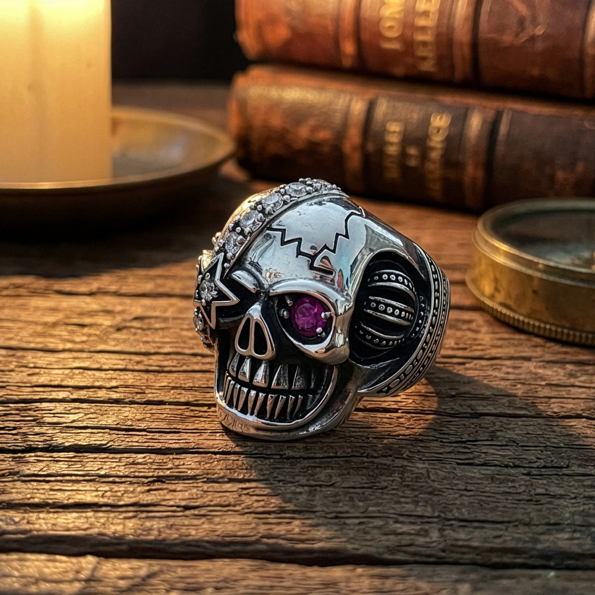 Stainless steel men's skull eye patch ring sitting on an old wooden table.