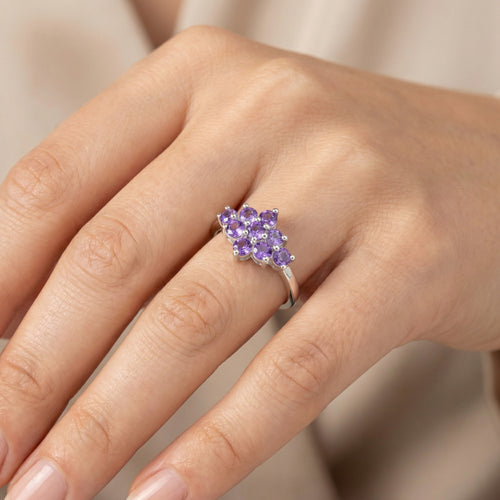 Woman wearing sterling silver amethyst cluster ring on her hand.