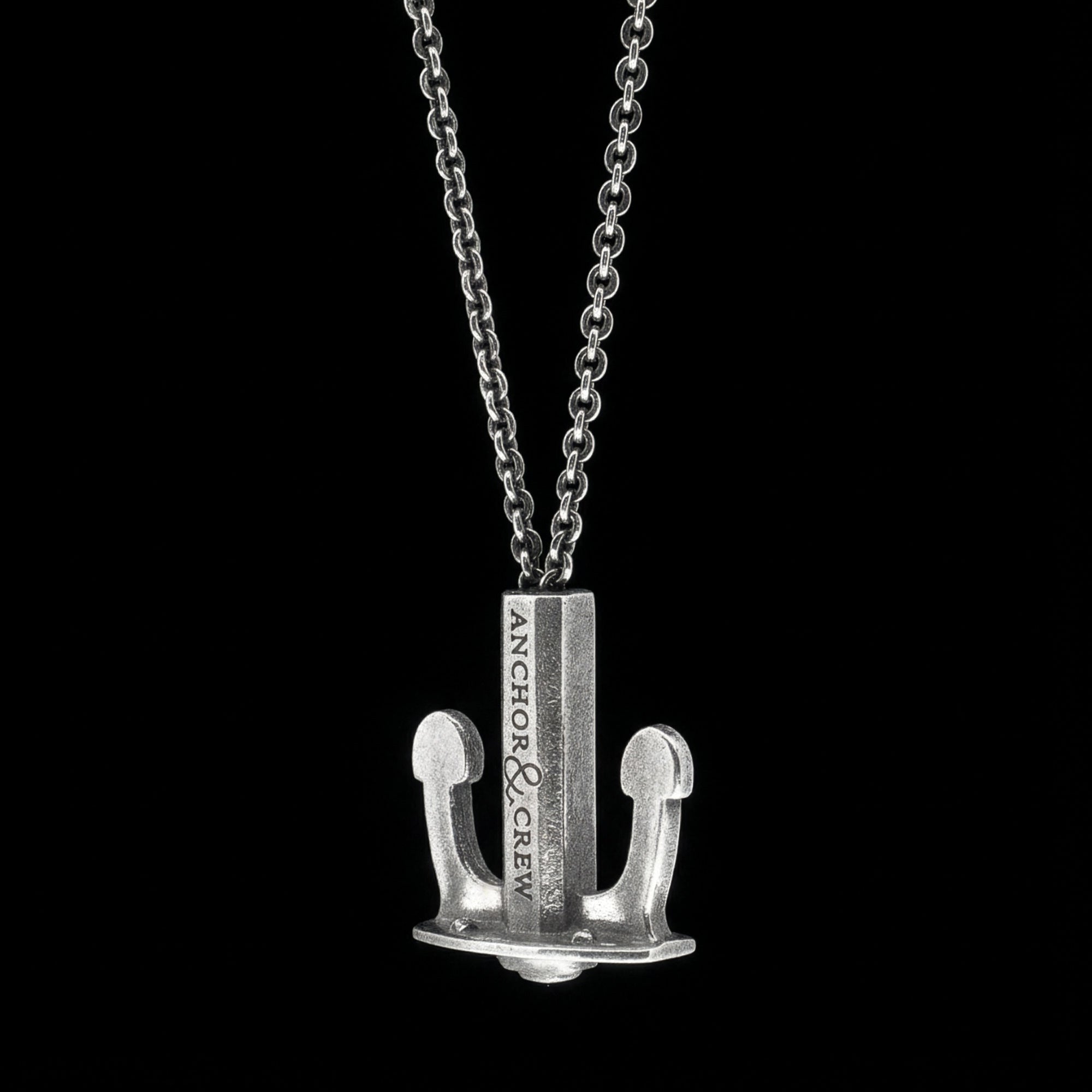 Side view of an Anchor & Crew Union anchor sterling silver necklace.