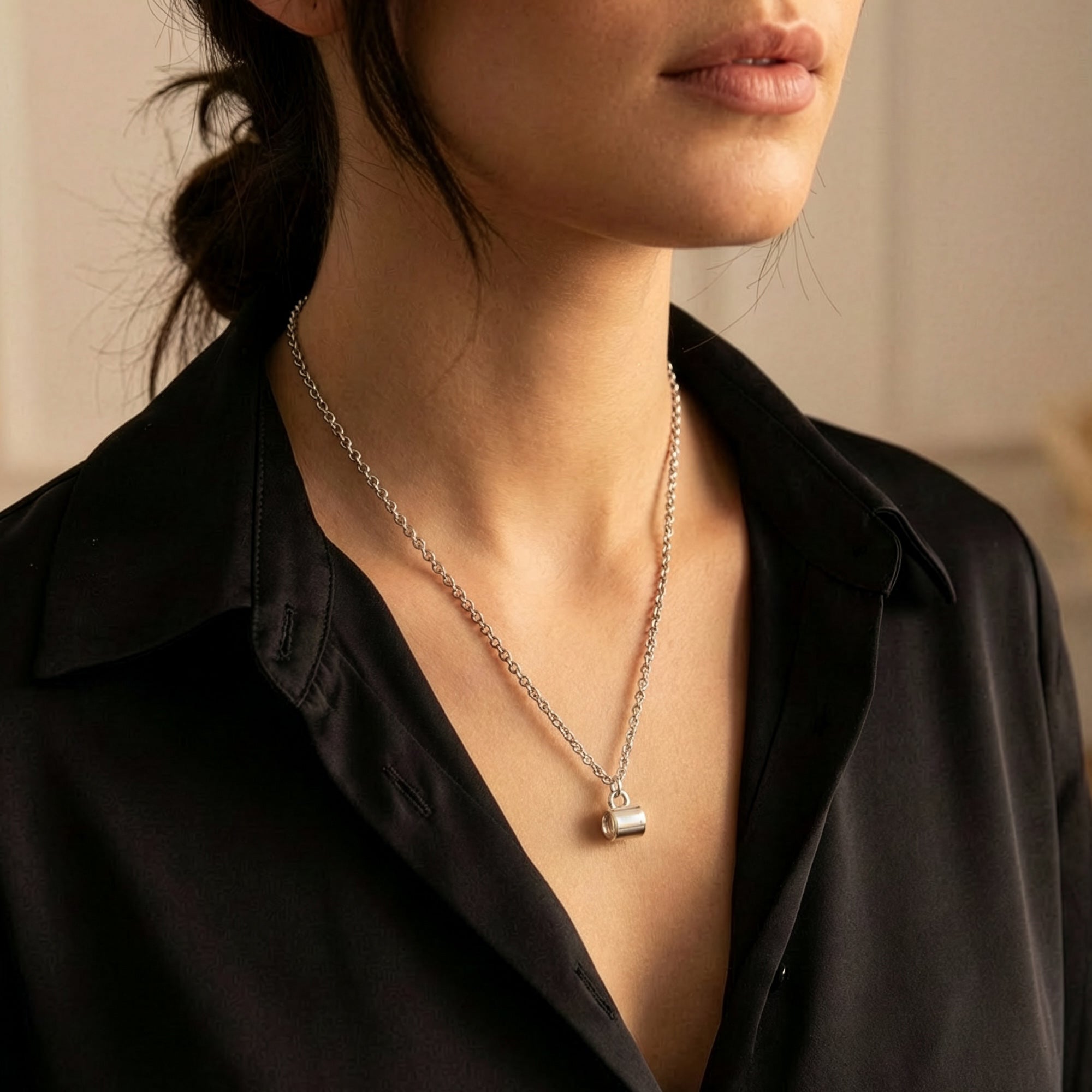 Woman wearing Anchor & Crew coffee mug sterling silver necklace.