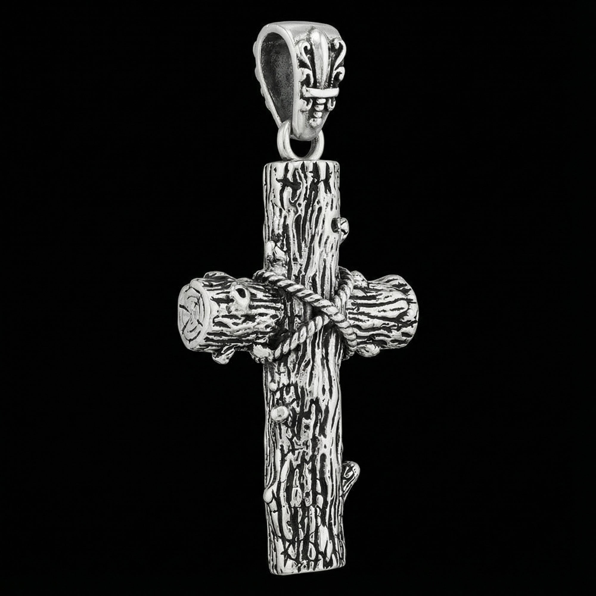 Sterling silver lashed wood cross necklace tilted to one side.