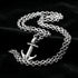 Anchor & Crew mini anchor sterling silver necklace on black velvet fabric.