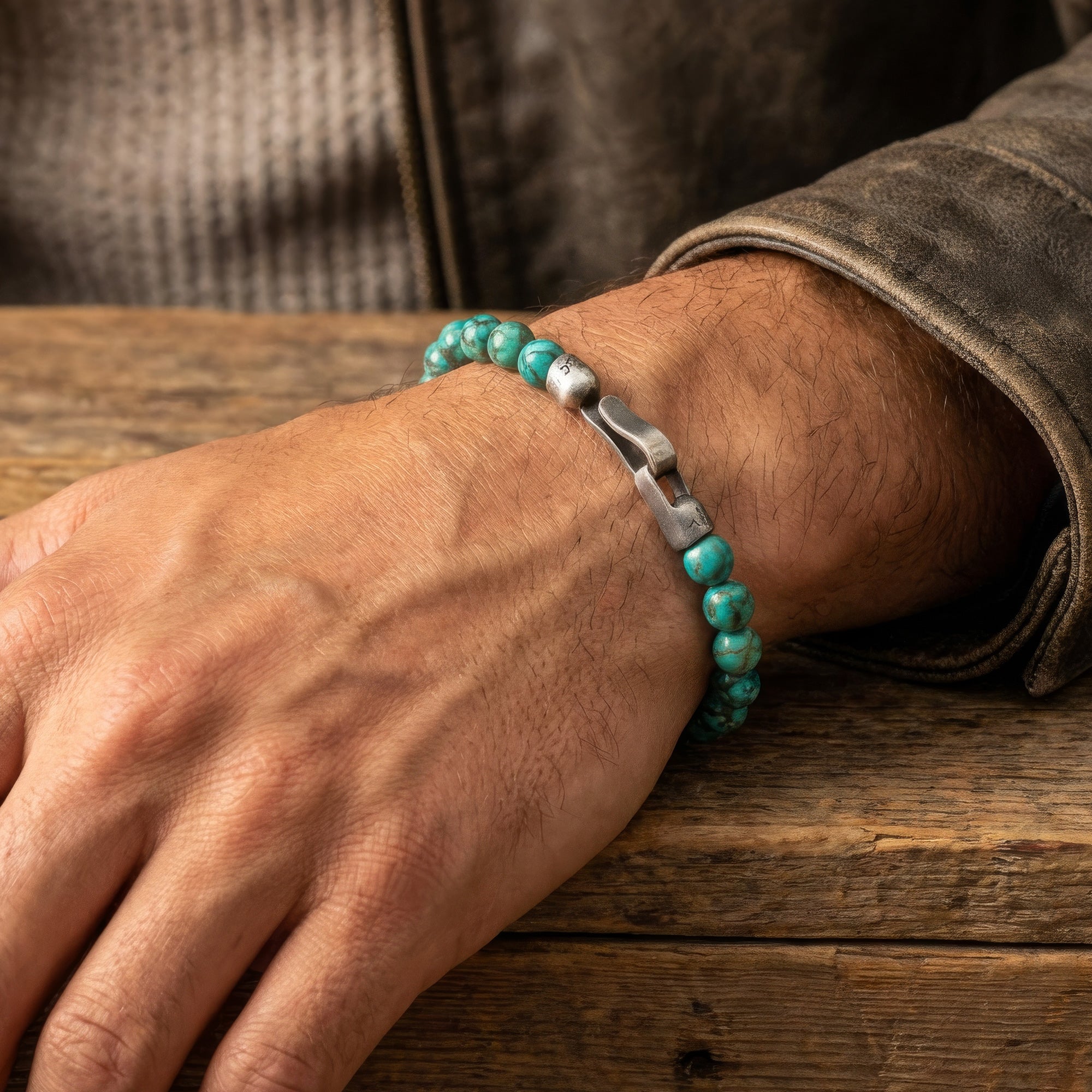 Man wearing Anchor & Crew Nachi sterling silver blue turquoise stone bracelet showing clasp.