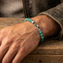 Man wearing Anchor & Crew Nachi sterling silver blue turquoise stone bracelet showing clasp.