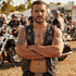 Biker man with his arms folded wearing sugar skull sterling silver men's necklace.