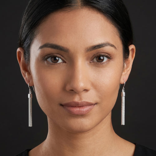 Woman wearing Engelsrufer tassel sterling silver drop earrings.